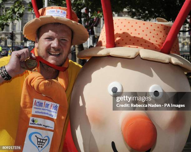 Charity fundraiser Lloyd Scott ceremoniously finishes the 2011 Virgin London Marathon after 26 days on the course dressed as a giant snail.