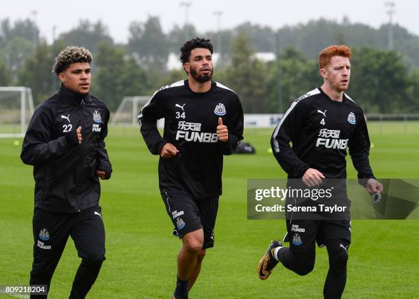 Newcastle players seen L-R DeAndre Yedlin, Emmanuel Riviere and Jack Colback jog around the pitchduring the Newcastle United Training session at the...