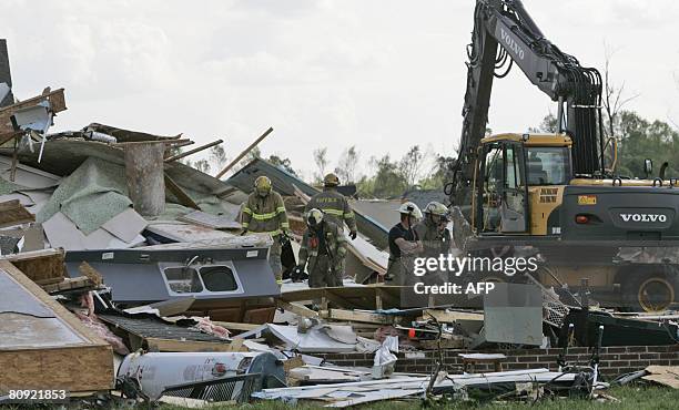 Firefighters conduct recovery efforts as they clear debris from a home in the Hillpoint Farms subdivision hit by a tornado April 29, 2008 in Suffolk,...