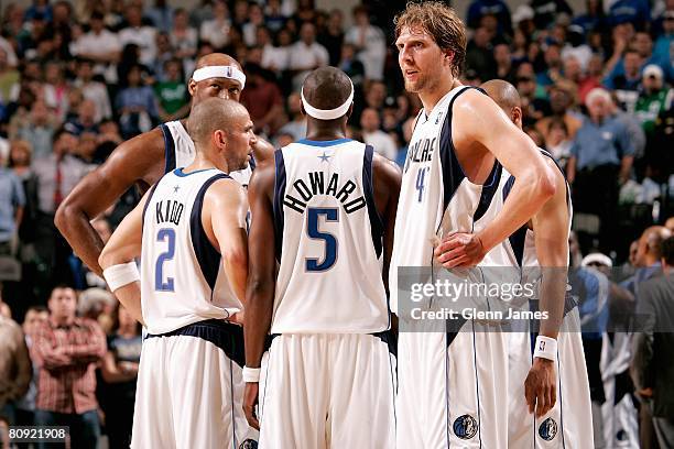 Dirk Nowitzki of the Dallas Mavericks stands on the court with his teammates in Game Three of the Western Conference Quarterfinals against the New...