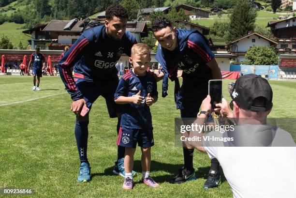 A father is making a picture of his son and Jairo Riedewald of Ajax and Abdelhak Nouri of Ajaxduring the pre-season summer training camp of Ajax...