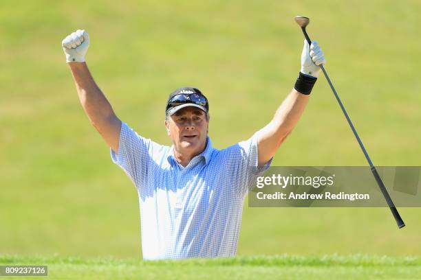 Nigel Mansell, former F1 World Champion, celebrates after holing his second shot for an eagle on the first hole during the Celebrity Golf Classic at...