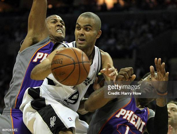 Tony Parker of the San Antonio Spurs passes in front of Raja Bell and Amare Stoudemire of the Phoenix Suns in a 92-87 win and a 4-1 series win in...