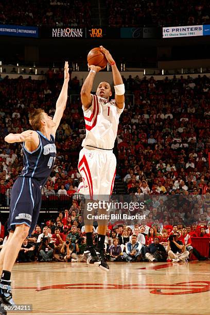 Tracy McGrady of the Houston Rockets shoots over Andrei Kirilenko of the Utah Jazz in Game Five of the Western Conference Quarterfinals during the...