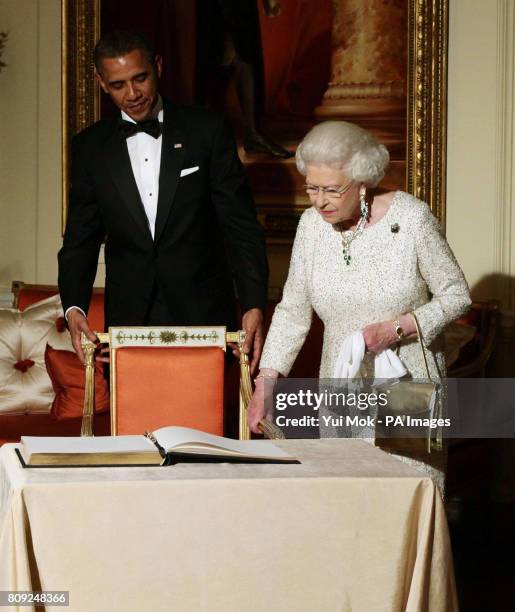 Queen Elizabeth II arrives to sign the guest book as she bids farewell to US President Barack Obama and First Lady Michelle Obama, watch by the Duke...