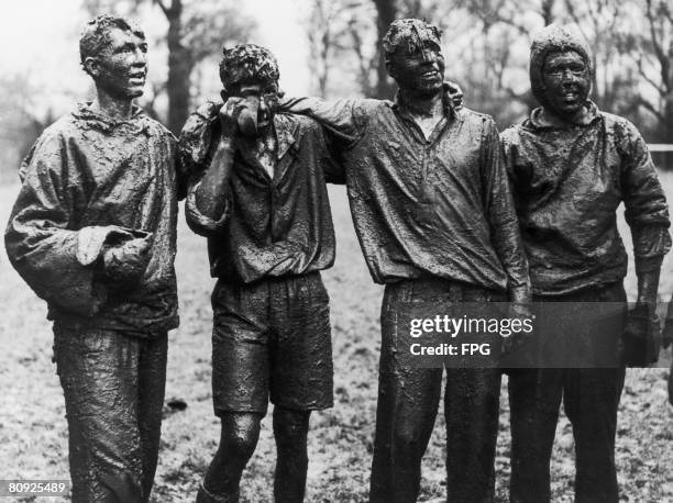 Mud covered pupils at Eton School after a 'Wall Game', May 1954. The game, which bears similarities to rugby union and soccer involves two teams...