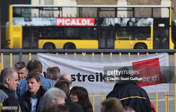 Striking bus drivers of the Berlin city transit authority stand gathered outside a BVG bus depot on the first day of the resumption of their off and...