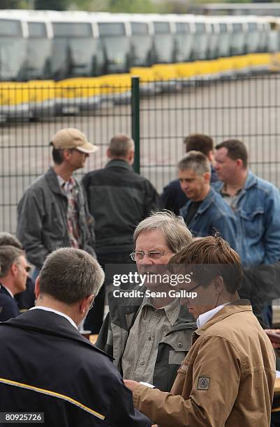 Striking bus drivers of the Berlin city transit authority stand gathered outside a BVG bus depot on the first day of the resumption of their off and...