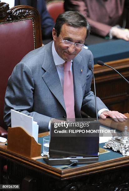 Former neo-fascist Gianfranco Fini, an ally of prime minister-elect Silvio Berlusconi, shakes smiles after being elected speaker of Italy's Chamber...