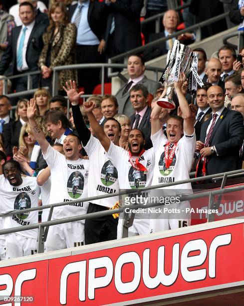 Swansea City's Garry Monk celebrates with the npower Championship Play Off trophy after winning promotion to the Premier League