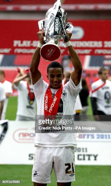 Swansea City's Scott Sinclair celebrates with the Championship Play Off trophy after winning promotion to the Premier League