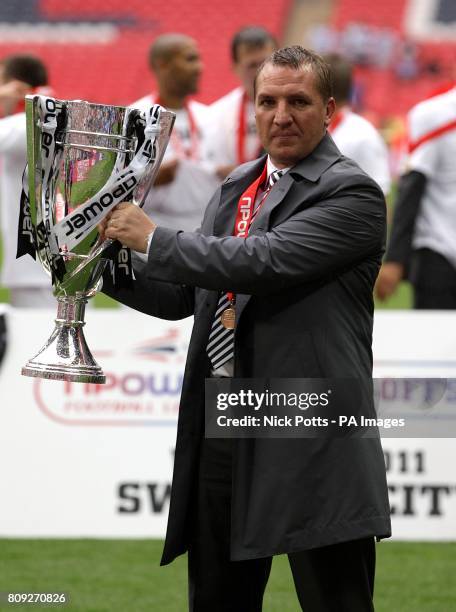 Swansea City manager Brendan Rodgers celebrates with the Championship Play Off trophy