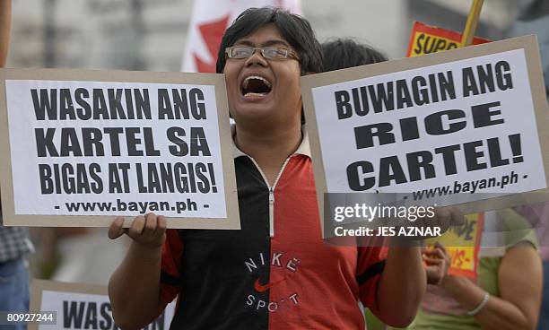 Protester hold placards and shouts slogans a day before the MayDay activities in Manila on April 30, 2008. The protesters called for additional wage...