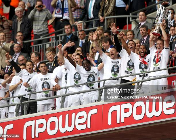 Swansea City's Garry Monk celebrates with the Championship Play Off trophy after winning promotion to the Premier League