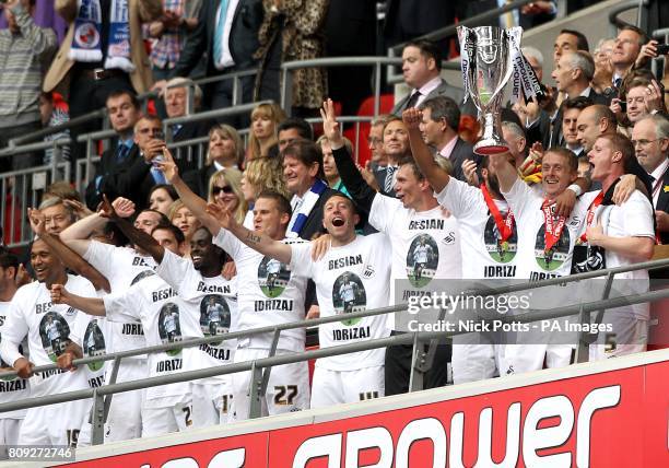 Swansea City celebrate with the Championship Play Off trophy after winning promotion to the Premier League