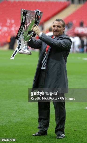 Swansea City manager Brendan Rodgers celebrates with the Championship Play Off trophy