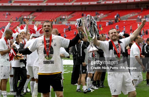 Swansea City's goalkeeper Dorus De Vries and Craig Beattie celebrate with the Championship Play Off Trophy