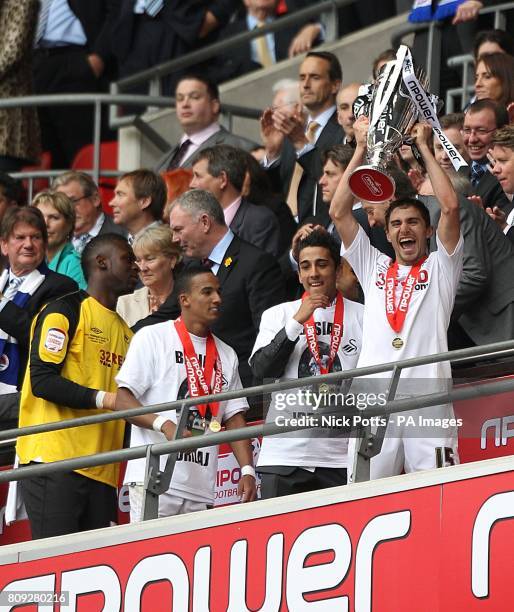 Swansea City's Fabio Borini holds the Championship Play Off trophy aloft