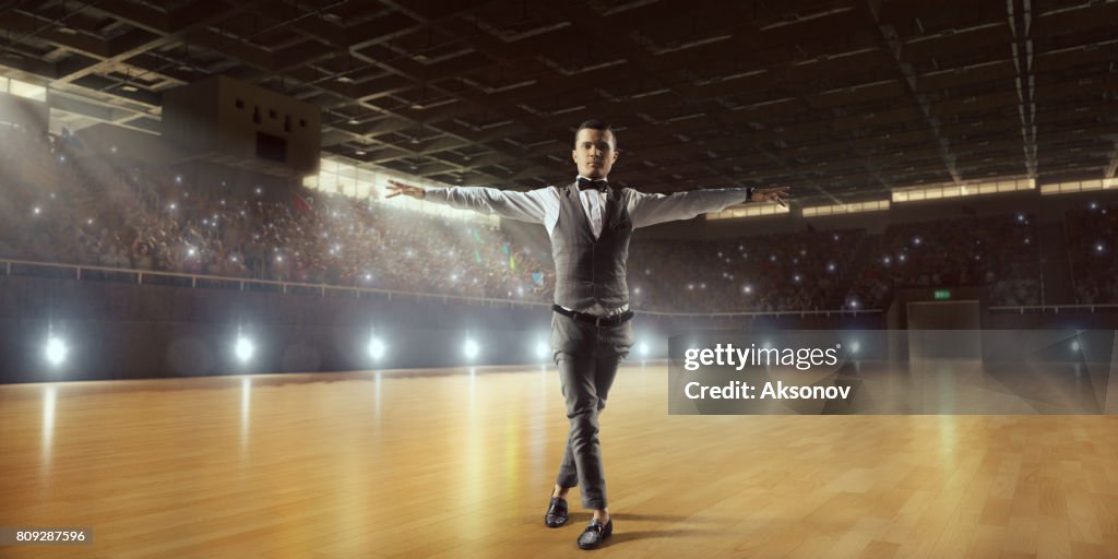 Male dancer ardently perform the latin american dance on a large professional stage