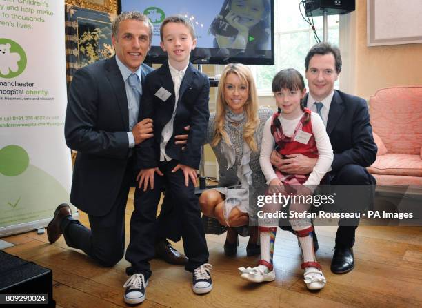 Chancellor George Osborne with Everton footballer Phil Neville, his wife Julie and their children Isabella and Harvey, at an event to raise money for...