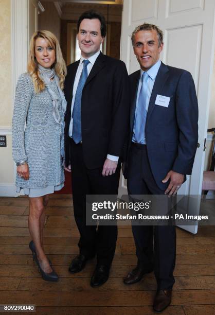 Chancellor George Osborne with Everton footballer Phil Neville, his wife Julie, at an event to raise money for the Royal Manchester Children's...