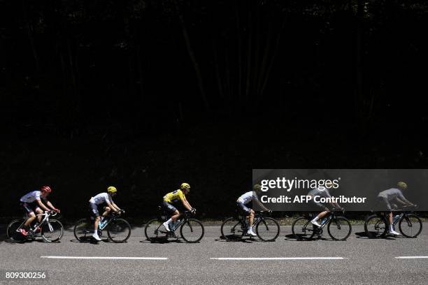 Great Britain's Geraint Thomas, wearing the overall leader's yellow jersey, rides with his teammates during the 160,5 km fifth stage of the 104th...