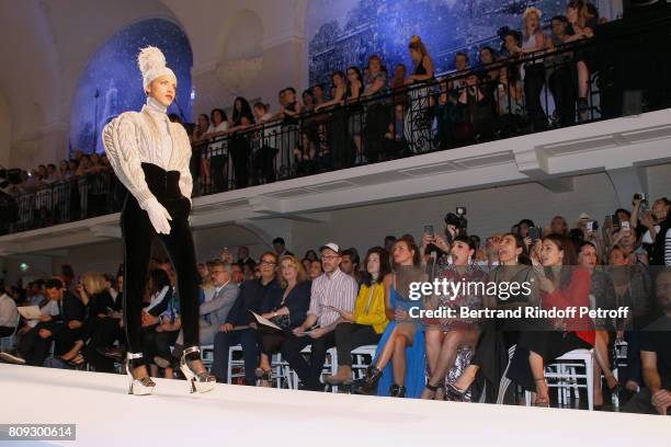 Model Noemie Lenoir walks the runway in front of Vincent Dedienne, Amanda Lear, Marc Puig, Gilles Dufour, Catherine Deneuve, Loic Prigent, Aloise...