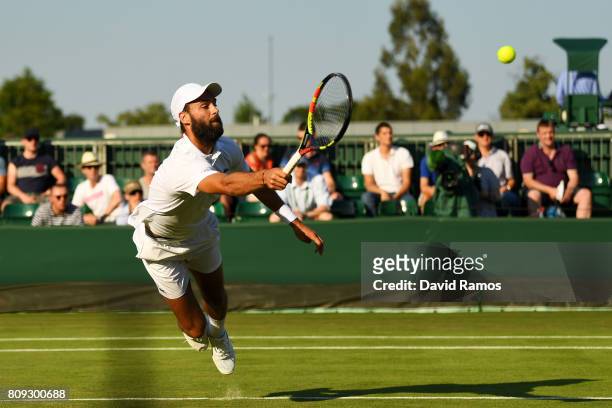Benoit Paire of France dives to play a forehand during the Gentlemen's Singles second round match against Pierre-Hugues Herbert of France on day...