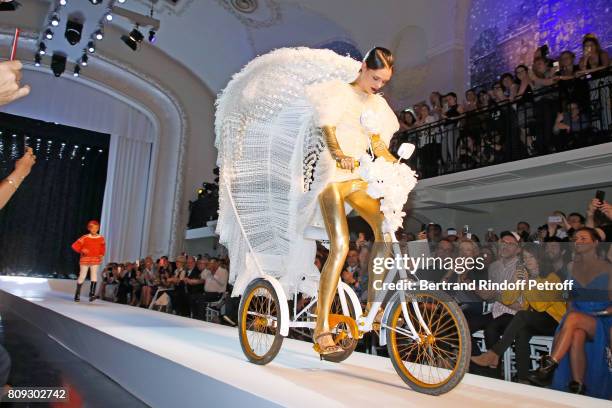 Coco Rocha wolks the runway in front of Catherine Deneuve, Loic Prigent, Aloise Sauvage and Fauve Hautot during the Jean Paul Gaultier Haute Couture...