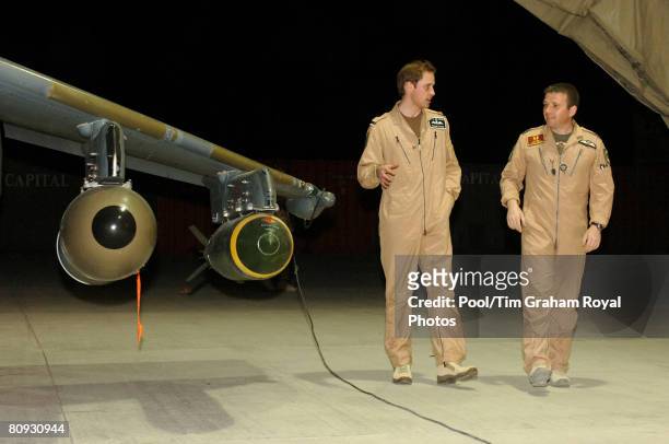 Flying Officer William Wales, Prince William, receives a briefing on the Harrier GR7A from Wing Commander Andy Lewis during a visit to Kandahar...