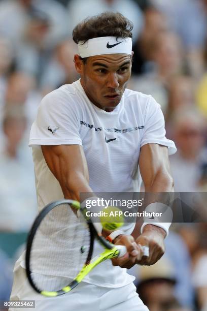 Spain's Rafael Nadal returns against US player Donald Young during their men's singles second round match on the third day of the 2017 Wimbledon...