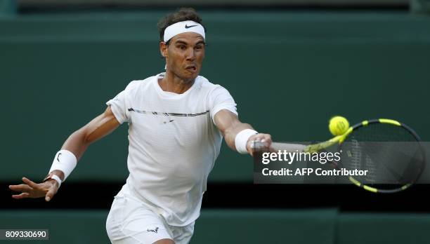 Spain's Rafael Nadal returns against US player Donald Young during their men's singles second round match on the third day of the 2017 Wimbledon...