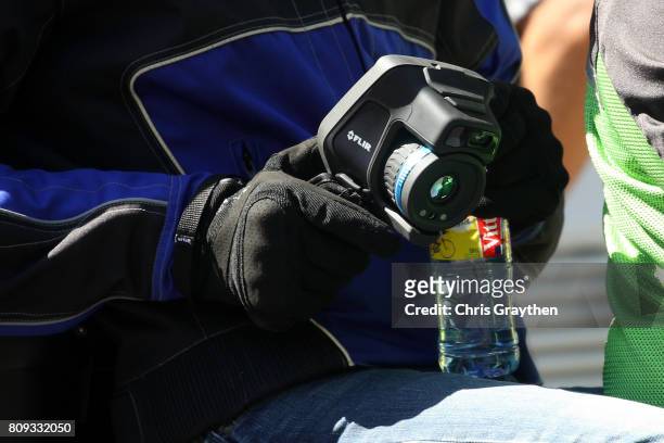 Official uses a FLIR thermal camera during stage five of the 2017 Le Tour de France, a 160.5km stage from Vittel to La plance des belles filles on...