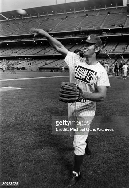 Kent McCord co-star of the hit 1970's TV show Adam 12 warms up before a charity baseball game against real cops on September 5 1972 at Dodger Stadium...