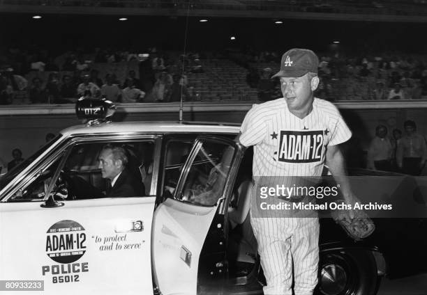 Martin Milner co-star of the hit 1970's TV show Adam 12 exits a squad car before a charity baseball game against real cops on September 5 1972 at...