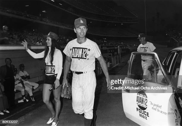Martin Milner and Kent McCord co-stars of the hit 1970's TV show Adam 12 head for the dugout before a charity baseball game against real cops on...