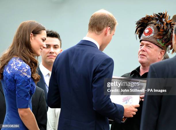 The Duke and Duchess of Cambridge receive a present from Grand Chief of the Huron-Wendat Indians, Konrad Sioui, as they leave HMCS Montreal at Quebec...