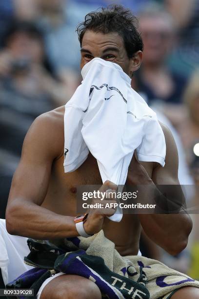 Spain's Rafael Nadal changes his t-shirt during a break in play against US player Donald Young during their men's singles second round match on the...