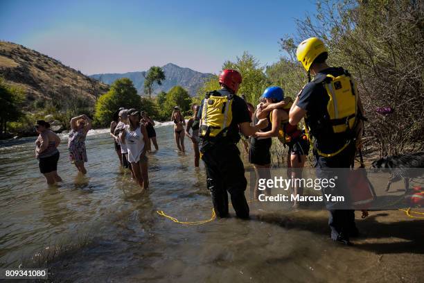 Search and rescue workers rescue Shannon Gilbert, second from right, who is getting a hug after getting out of the water, near Kernville, Calif., on...
