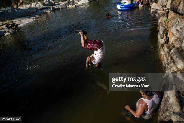 The Martinez & Bererra family from Los Angeles, play in the Kern River at Keyesville Camp near Lake Isabella, Calif., on July 3, 2017.