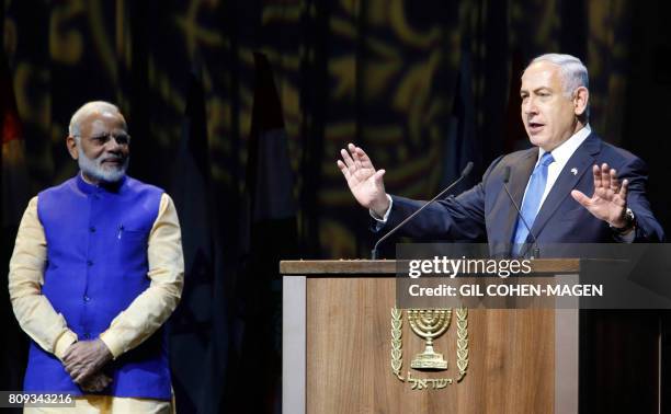 Israeli Prime Minister Benjamin Netanyahu greets his Indian counterpart Narendra Modi during a meeting with Indian community at the Tel Aviv...