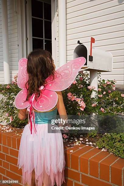 young fairy girl looking in mailbox - domestic mailbox stock-fotos und bilder