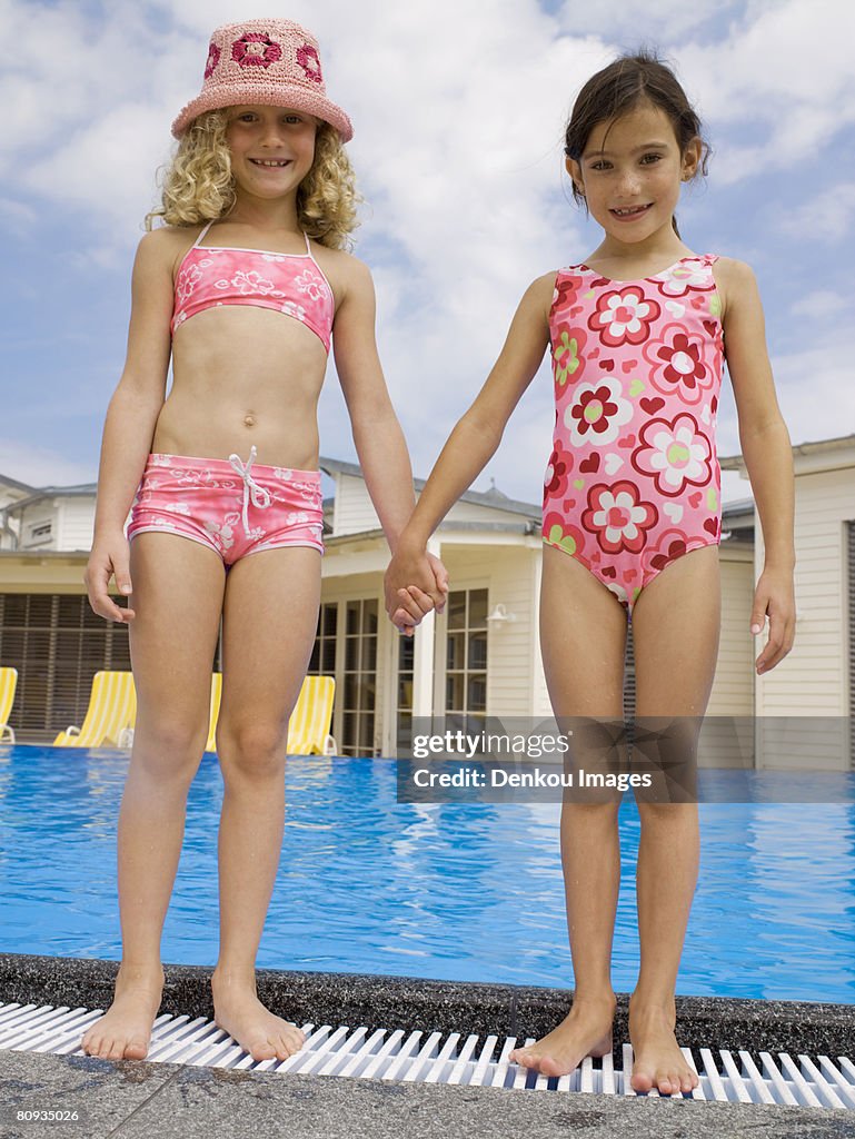 Girls holding hands near pool