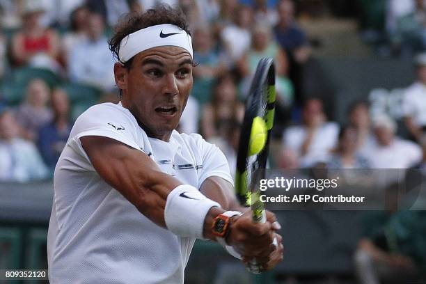 Spain's Rafael Nadal returns against US player Donald Young during their men's singles second round match on the third day of the 2017 Wimbledon...