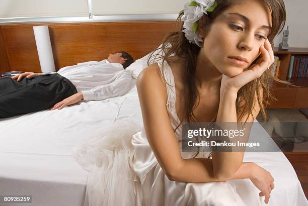 sad bride with groom asleep in background - sad groom stock pictures, royalty-free photos & images