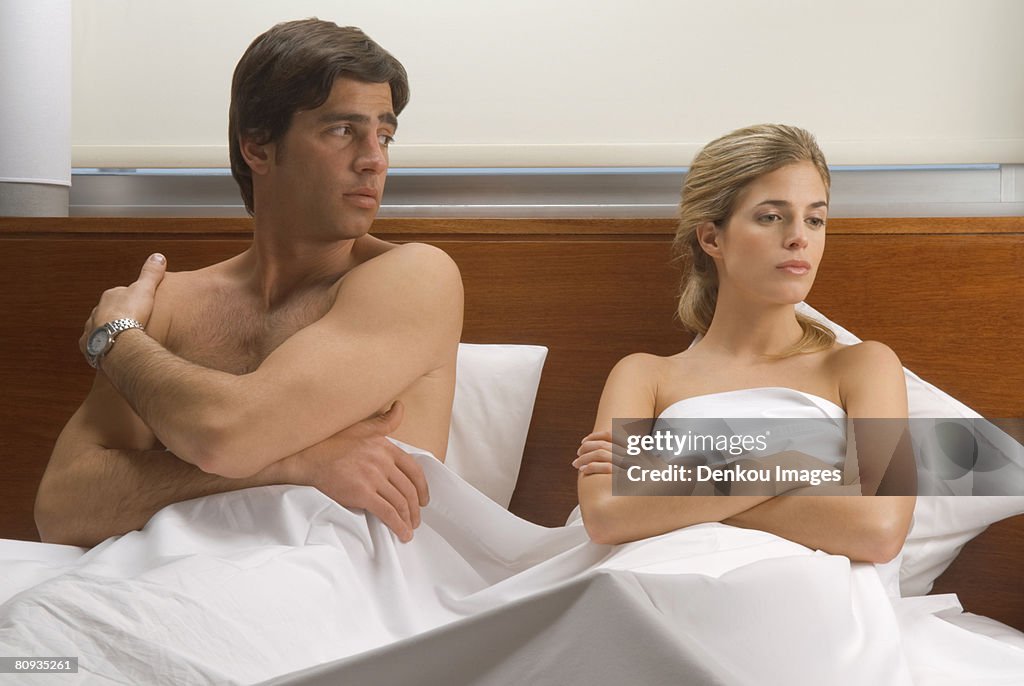 Upset couple in bed
