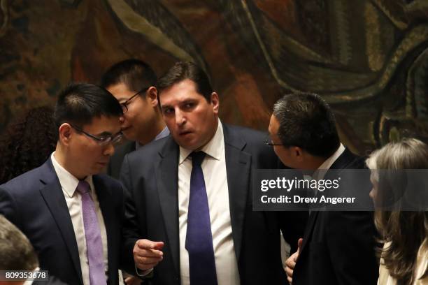 Russian Deputy Permanent Representative to the United Nations Vladimir Safronkov speaks with members of the Chinese delegation during an emergency...