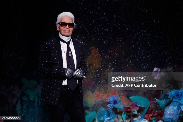 German fashion designer Karl Lagerfeld acknowledges the audience at the end of Fendi 2017-2018 fall/winter Haute Couture collection in Paris on July...