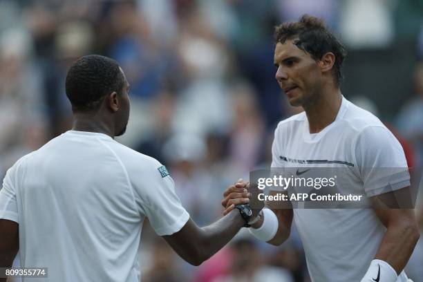 Spain's Rafael Nadal shakes hands with US player Donald Young after winning their men's singles second round match on the third day of the 2017...