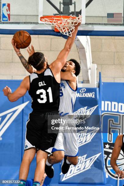 Michael Gbinije of the Detroit Pistons goes for a lay up during the game against Anthony Gill of the Charlotte Hornets during the 2017 Orlando Summer...